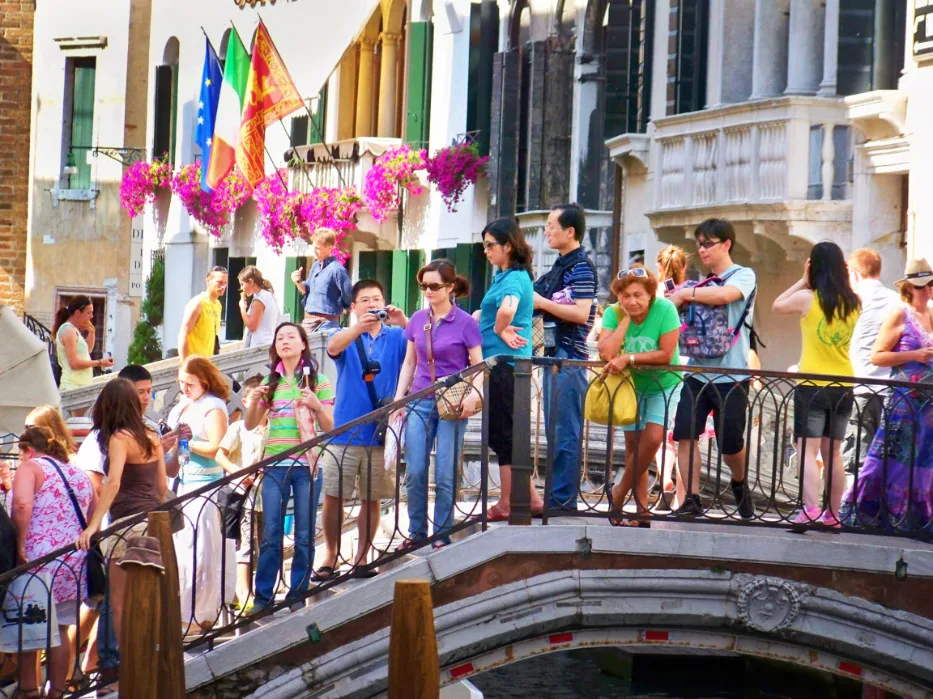 Tourists on footbridge in Venice Italy 1