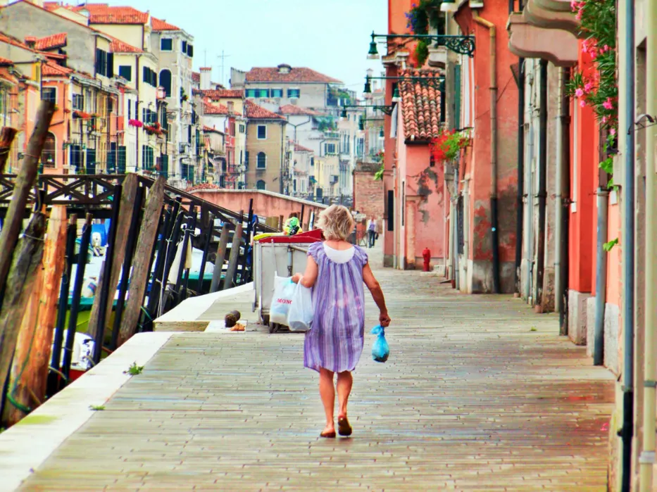 Venetian woman walking along docks in pajamas Venice Italy 1