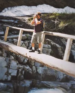 Chris Taylor crossing Log Bridge over Nisqually River in Mt Rainier National Park 2traveldads.com