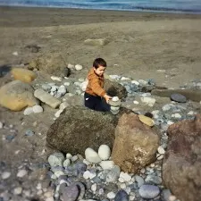 LittleMan stacking rocks on beach at Point Wilson Lighthouse Fort Worden Port Townsend 1