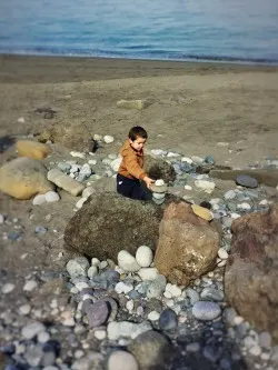 LittleMan stacking rocks on beach at Point Wilson Lighthouse Fort Worden Port Townsend 1