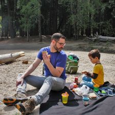 Chris Taylor and LittleMan picnic at Cathedral Merced River in Yosemite National Park 2traveldads.com (1)