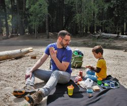 Chris Taylor and LittleMan picnic at Cathedral Merced River in Yosemite National Park 2traveldads.com (1)