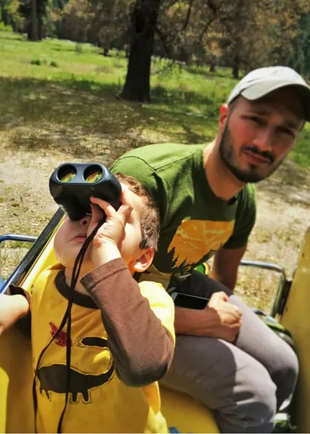 LittleMan and Rob Talor with binoculars on tram tour Yosemite National Park 2traveldads.com