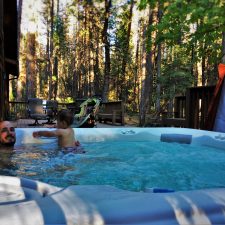 Rob Taylor and TinyMan in hot tub at John Muir House at Evergreen Lodge at Yosemite National Park 1