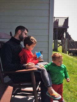 Chris Taylor and kids in rocking chair at Pacific Reef Hotel Gold Beach Southern Oregon Coast