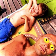 Rob Taylor and LittleMan lying in sun