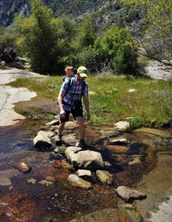 Chris Taylor and TinyMan crossing creek at Hetch Hetchy Yosemite National Park 1