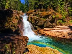 Clear water and colorful rocks and rainbow at Silver Falls Mt Rainier National Park 1