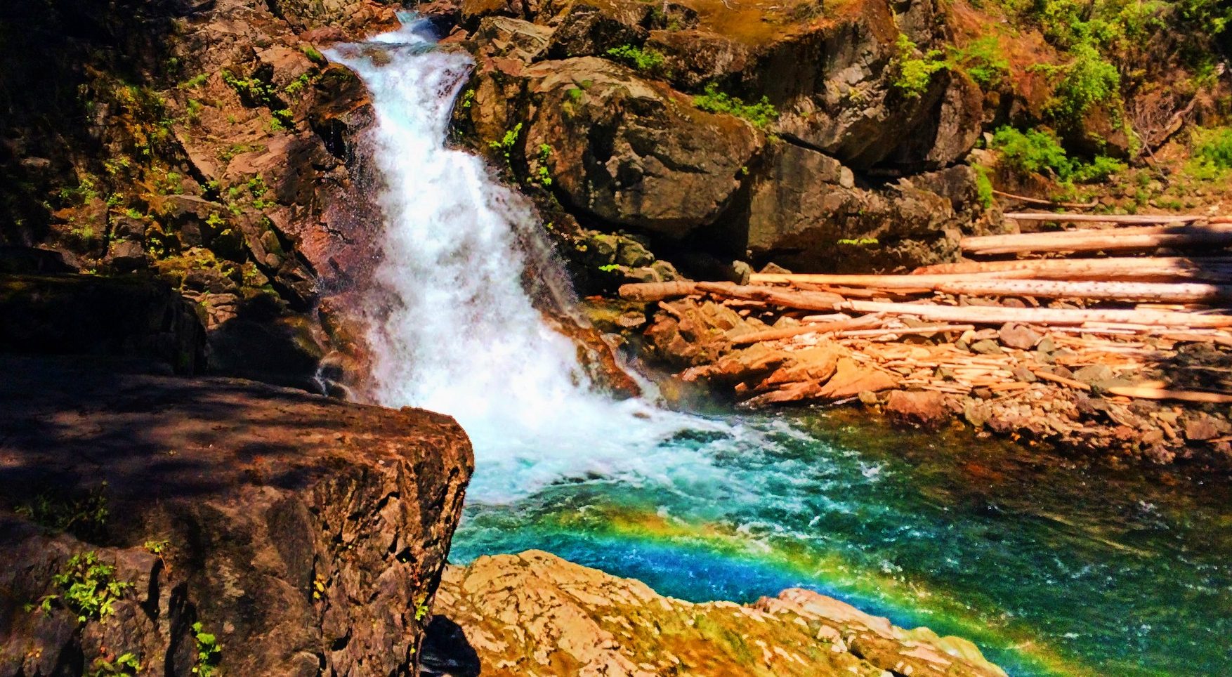 Clear water and colorful rocks and rainbow at Silver Falls Mt Rainier National Park 1