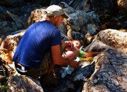 Rob Taylor and TinyMan diaper change on rocks at Silver Falls Mt Rainier National Park 1