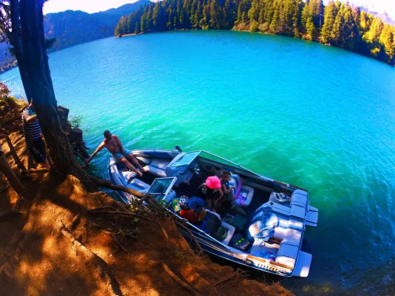 Tying up speed boat at cove at Lake Cushman Olympic Peninsula 2