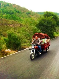 Man on scooter in rural YanAn Shaanxi 1