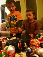 Our kids love sorting through ornaments to decorate a Christmas tree. A wonderful family tradition. 2traveldads.com