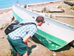 Chris Taylor with abandoned boat at Dungeness Spit