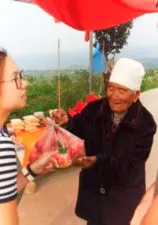 Old lady selling fruit at rural road Yanan Shaanxi 1