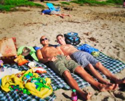 Taylors sun tanning at beach in Orange County