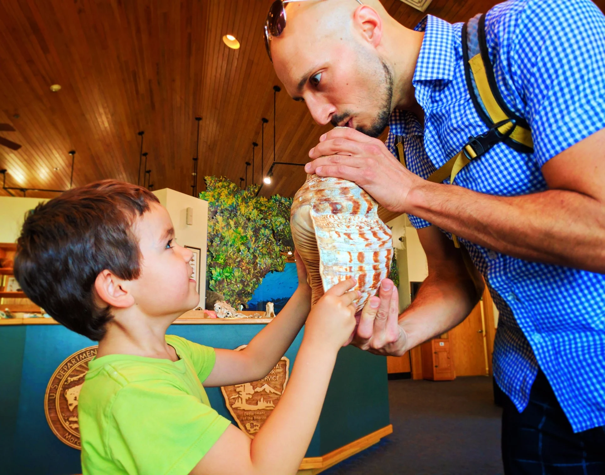 Taylor Family playing conch shell in Biscayne National Park Visitors Center 1
