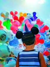 Taylor-family-with-colorful-balloons-at-Disneyland-1-169x225.jpg