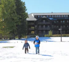 Taylor Family playing in snow at Glacier Park Lodge East Glacier