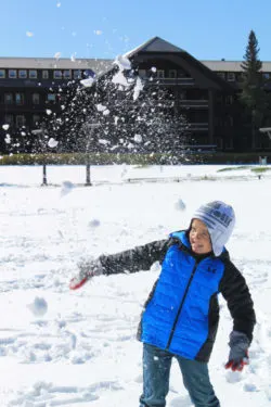 Taylor Family playing in snow at Glacier Park Lodge East Glacier