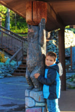 Taylor-Family-with-Bear-carving-at-West-Glacier-Amtrak-Train-Station-1-150x225.jpg