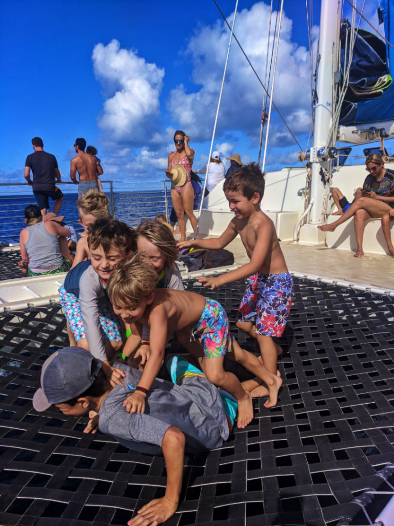 Taylor family and friends playing on catamaran off Oahu 1
