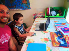 Taylor Family doing writing workbooks WorldSchooling 2