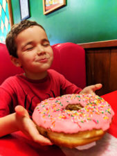 Taylor Family eating big pink donut Springfield Universal Studios Orlando