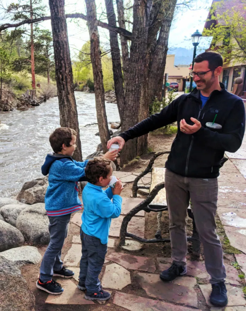 Taylor family walking along Big Thompson River in Downtown Estes Park Colorado 3