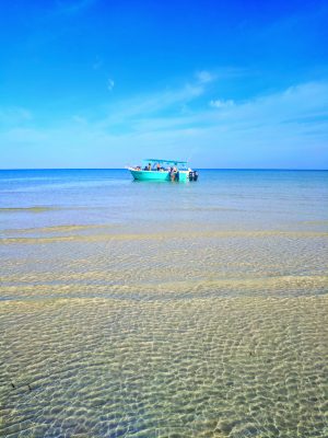 Boat in Turquoise water on beach at Isla Holbox Yucatan 1