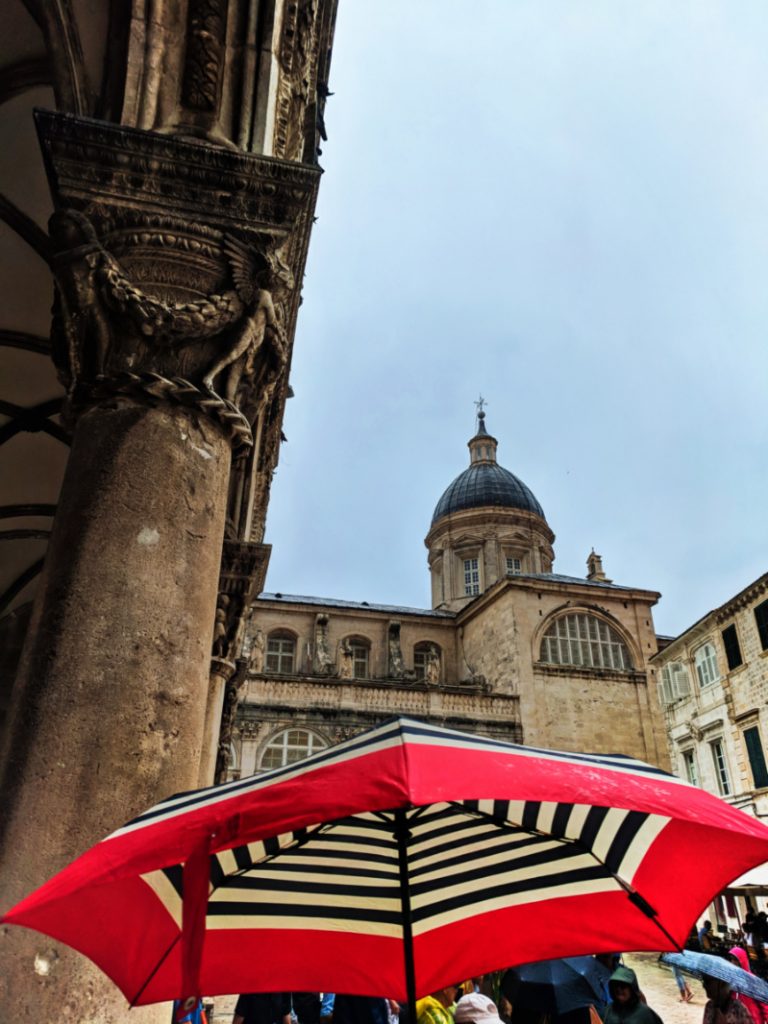 Cathedral and red umbrella in the Rain Old Town Dubrovnik Croatia 1