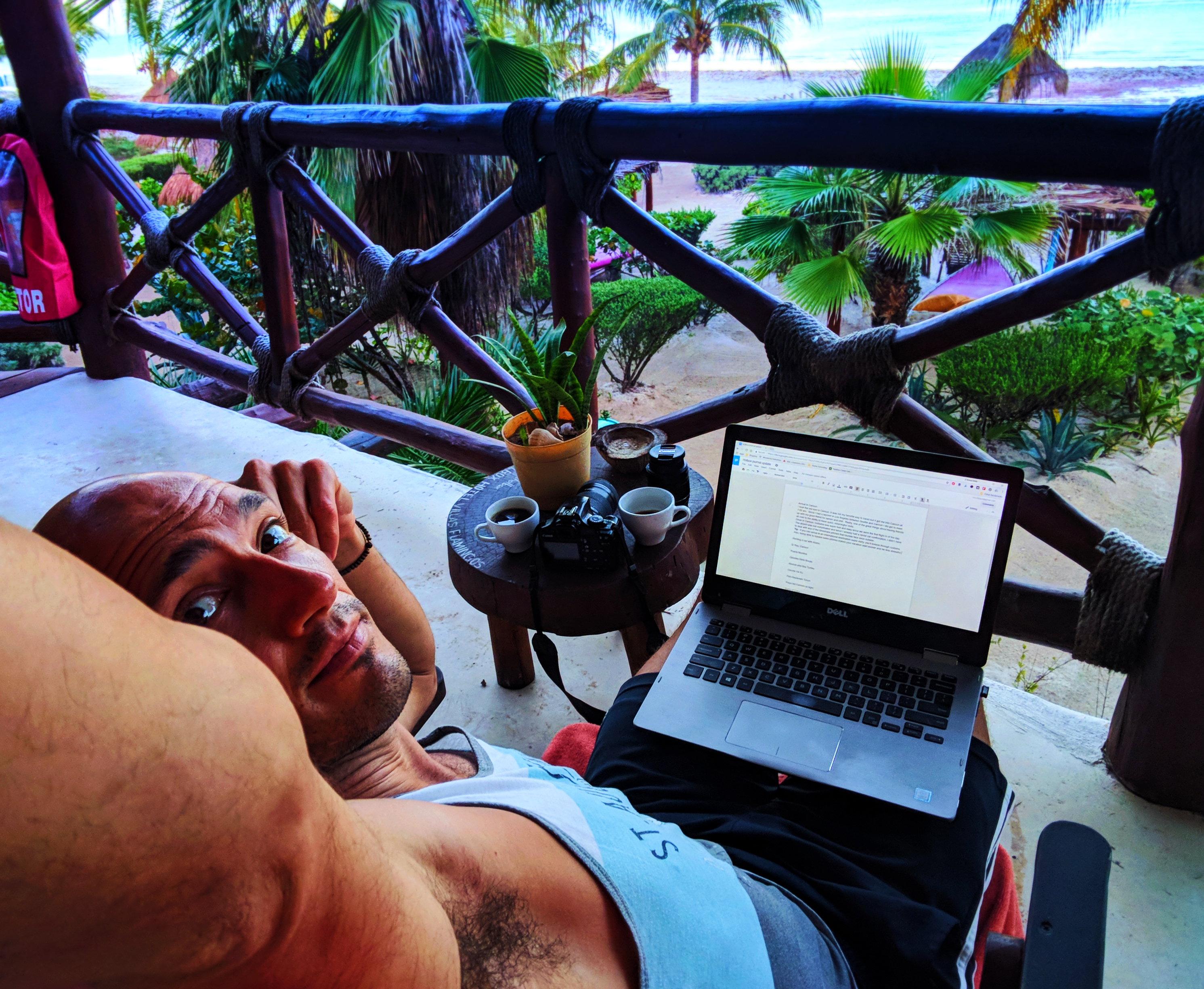 Rob Taylor with Laptop on balcony at sunrise Villas Flamingos Isla Holbox Yucatan 1