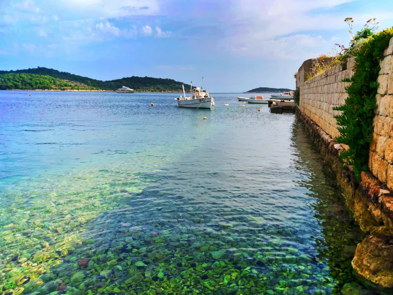 Colorful water at city wall Port of Vis Croatia 1