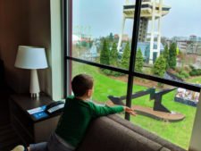 Taylor-Family-and-Space-Needle-through-living-room-windows-at-Hyatt-House-Seattle-1-225x169.jpg