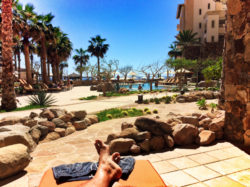 Taylor Family relaxing on patio with pools at Grand Solmar Resort Cabo San Lucas 2