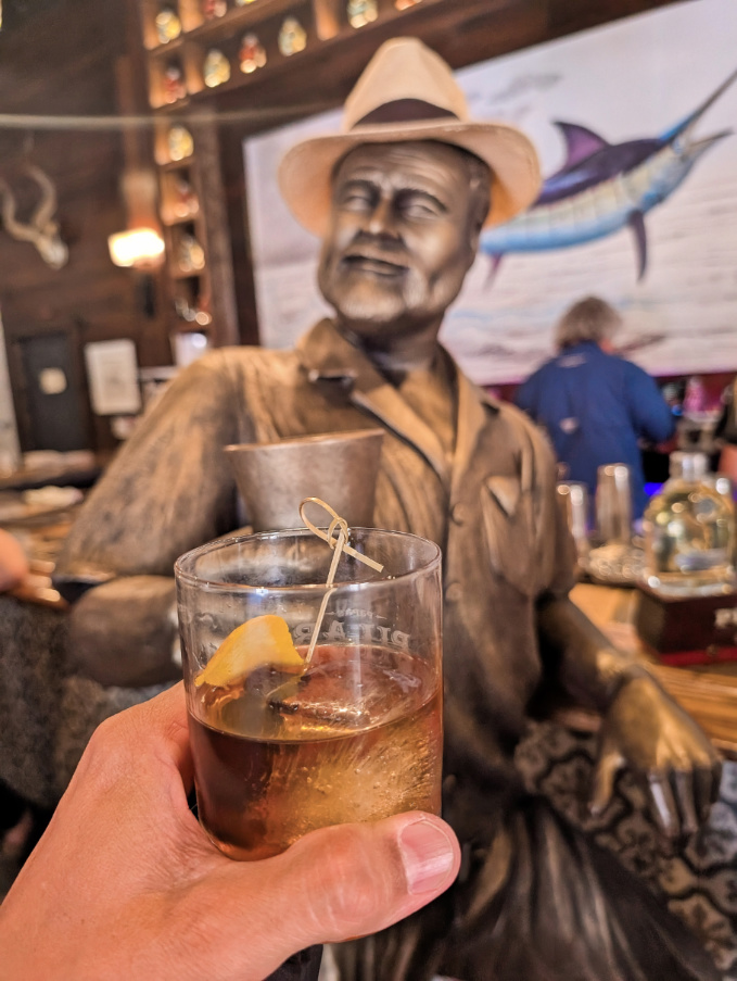 Cheers with Bronze Hemingway Statue in Hemingway Social Club at Distillery Key West Florida Keys 1