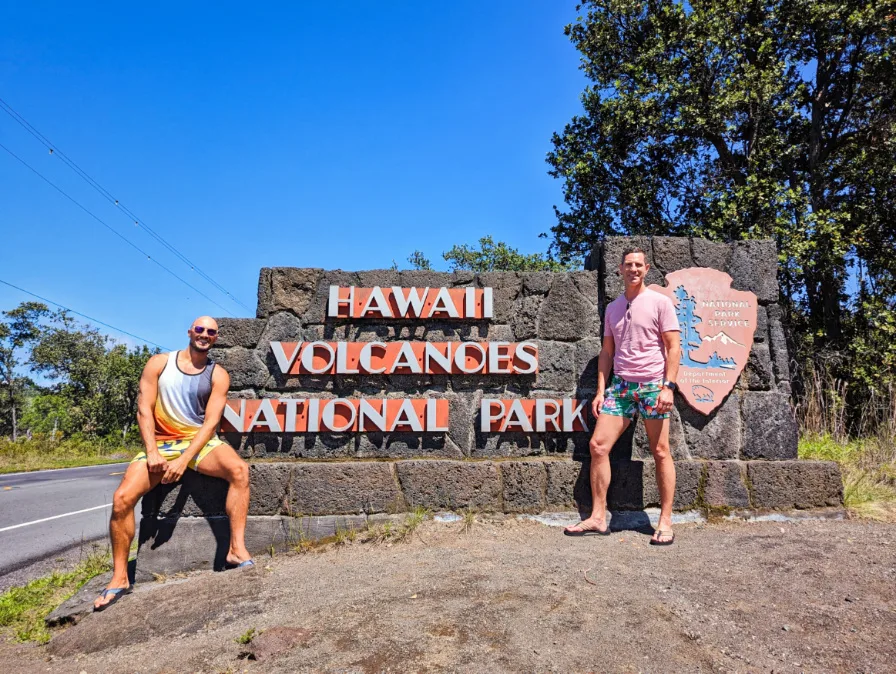 https://2traveldads.com/wp-content/uploads/Chris-and-Rob-Taylor-at-Entrance-Sign-Hawaii-Volcanoes-National-Park-Big-Island-Hawaii-1b-1.jpg.webp