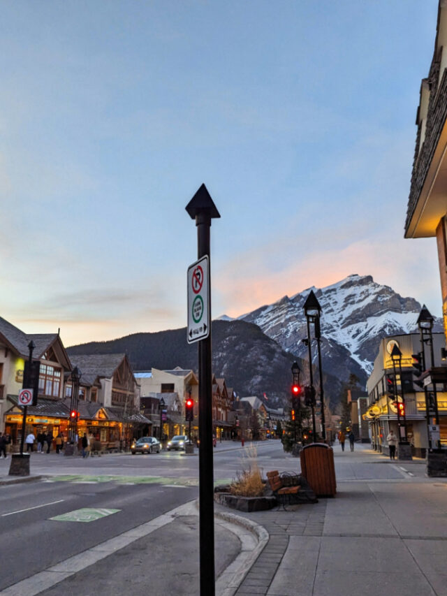 Exterior of Mount Royal Hotel with Canadian Rockies at Sunset downtown Banff Alberta 1