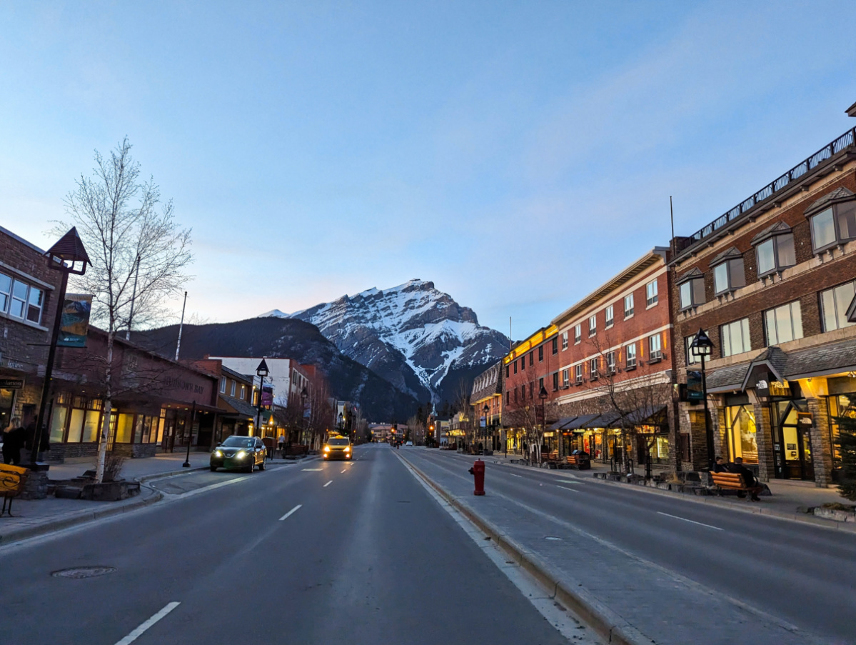 Exterior of Mount Royal Hotel with Canadian Rockies at Sunset downtown Banff Alberta 2