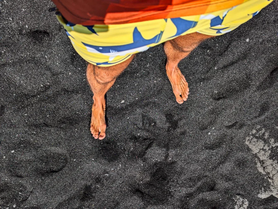 Feet on Black Sand Beach Punlaluu Big Island Hawaii 1