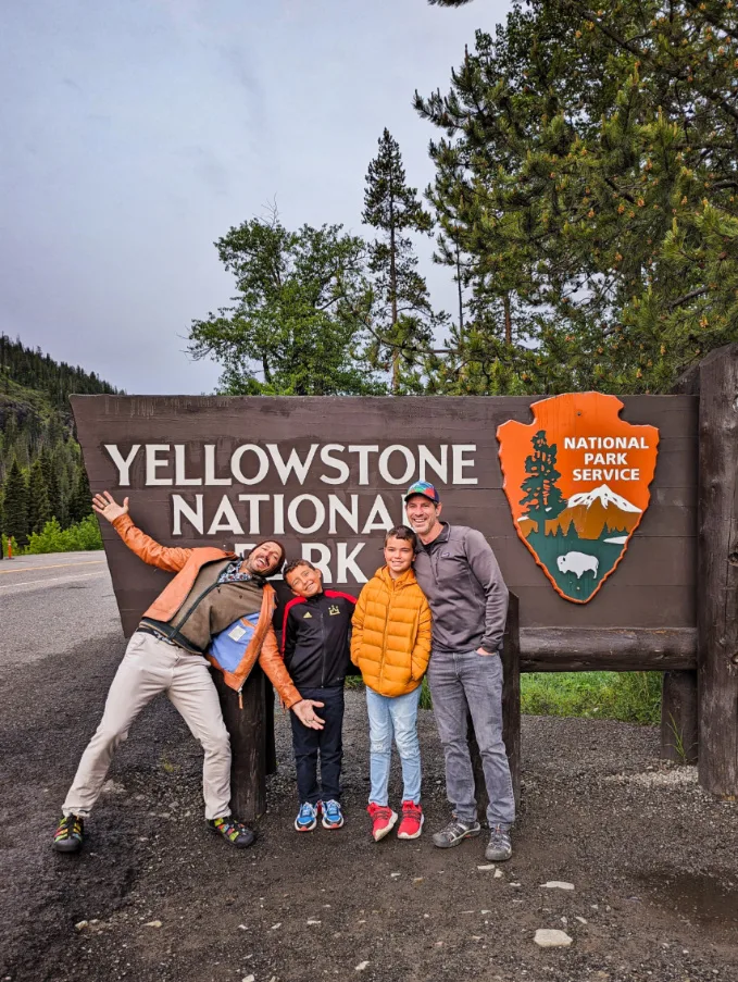 Full Taylor Family at Cody Entrance Sign at Yellowstone National Park Wyoming 2