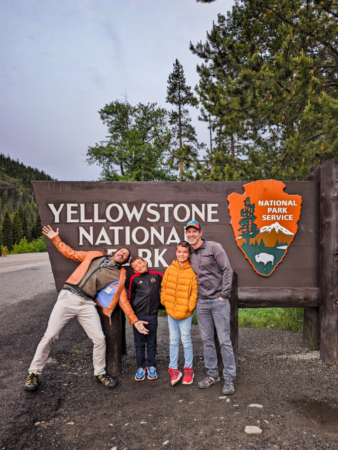 Full Taylor Family at Cody Entrance Sign at Yellowstone National Park Wyoming 2