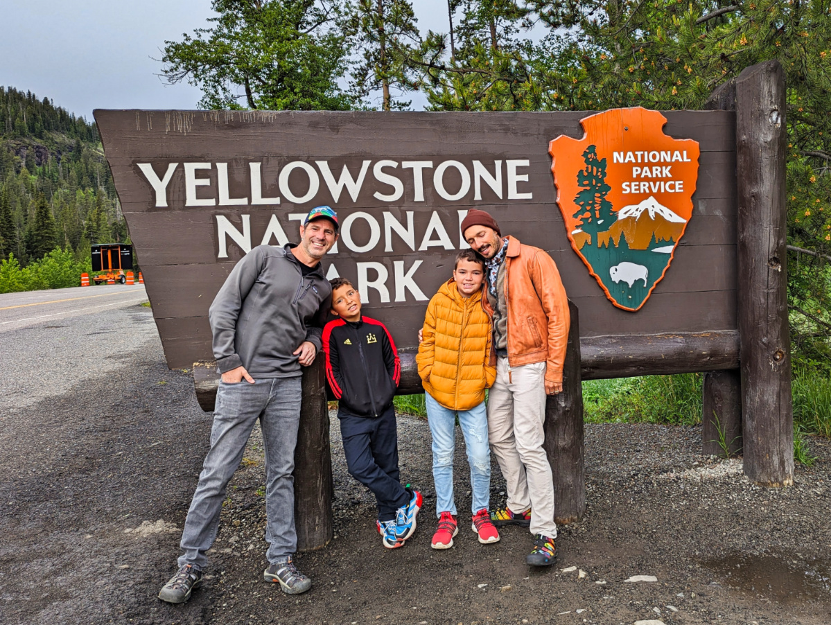 Full Taylor Family at Cody Entrance Sign at Yellowstone National Park Wyoming 3