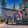 Full Taylor Family at Entrance Sign Yellowstone National Park 5