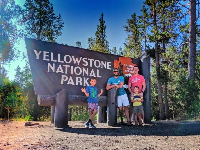 Full Taylor Family at Entrance Sign Yellowstone National Park 5