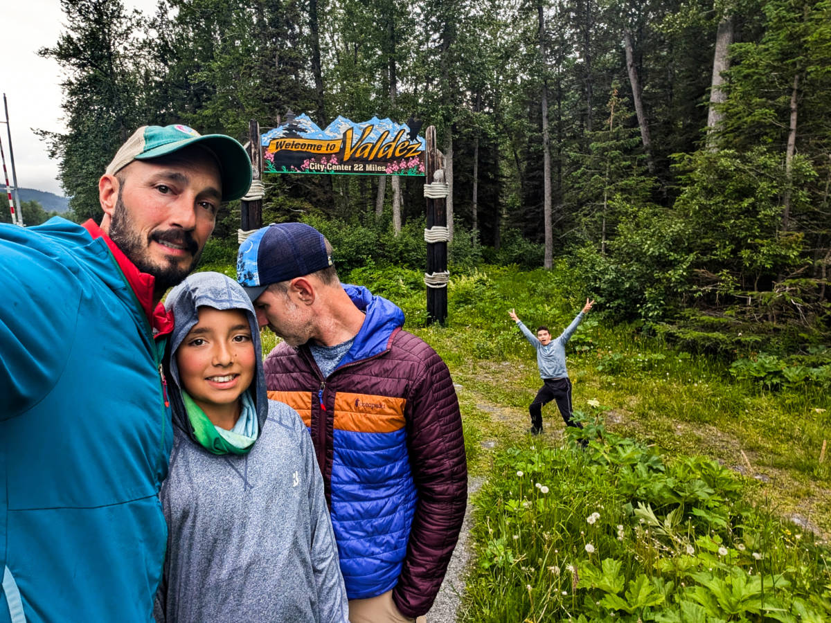 Full Taylor Family with Welcome to Valdez Sign on Richardson Highway Valdez Alaska
