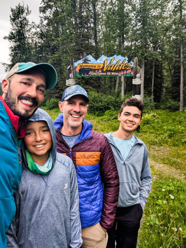 Full Taylor Family with Welcome to Valdez Sign on Richardson Highway Valdez Alaska