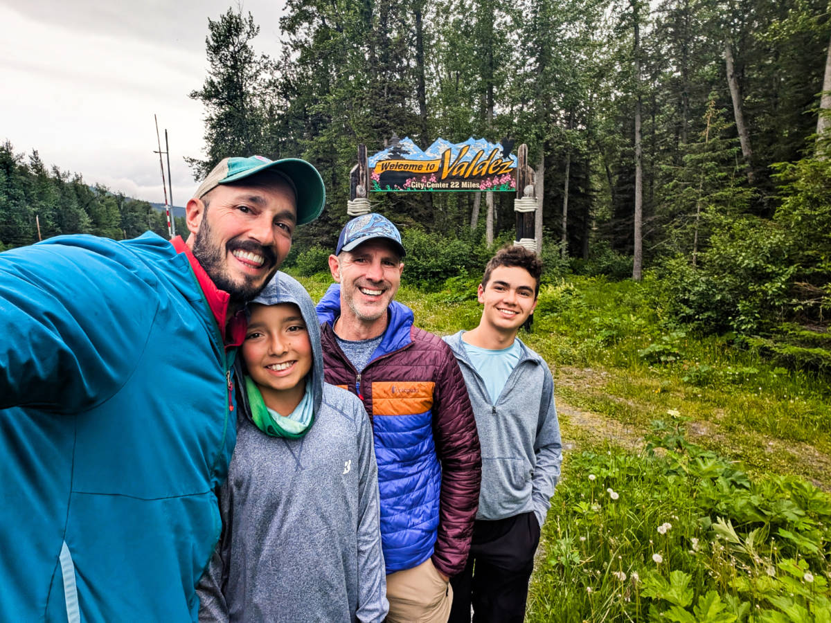 Full Taylor Family with Welcome to Valdez Sign on Richardson Highway Valdez Alaska