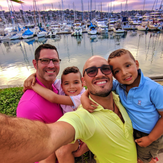 Full Taylor family walking in marina sunset at Island Palms Best Western San Diego California 1